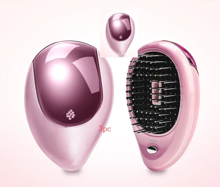 Pink electric sound wave vibration magnetic massage comb with ergonomic handle and negative ion function