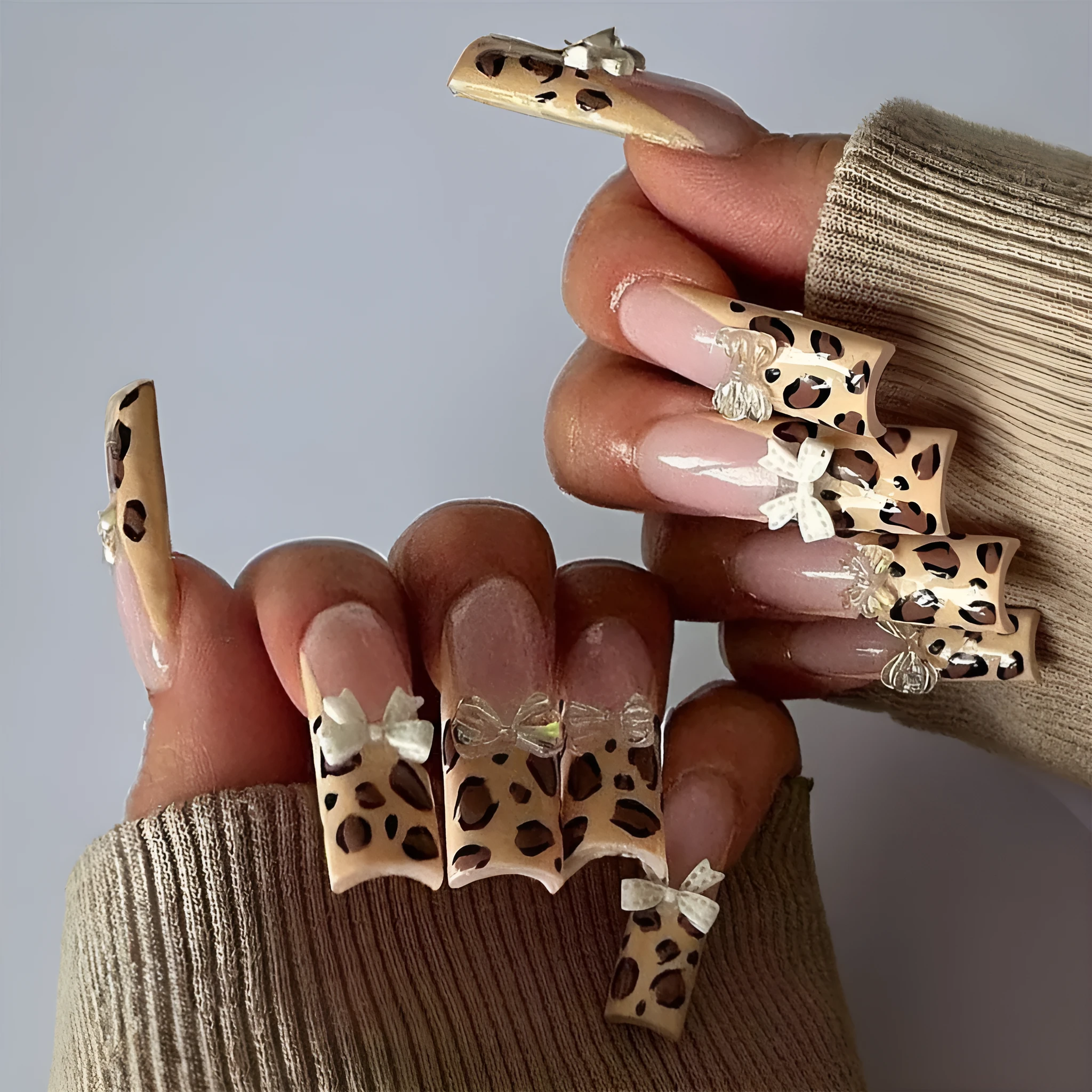 Leopard print butterfly nail art pieces on plastic backing for manicure decoration