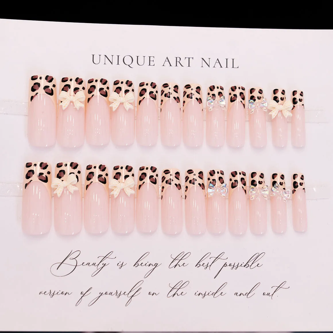 Leopard print butterfly nail art pieces on plastic backing for manicure decoration