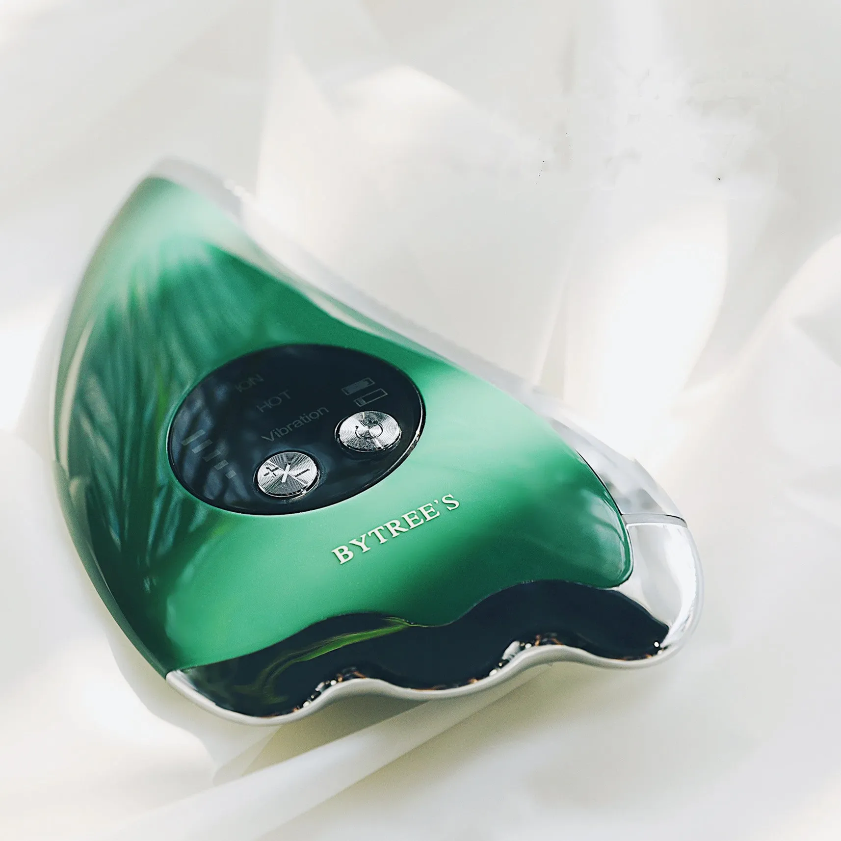 Green plastic and metal facial beauty instrument with three mode buttons and USB cable