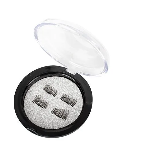 Stainless steel fine mesh tea strainer on a white background with loose tea leaves nearby