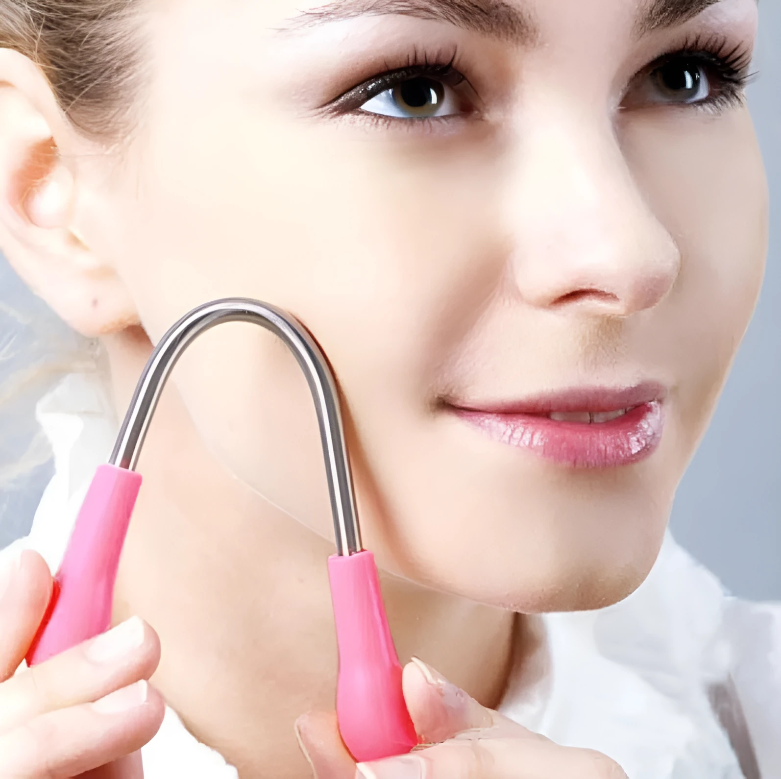 Pink facial hair remover with stainless steel spring and plastic handles, 19cm long, on a light background