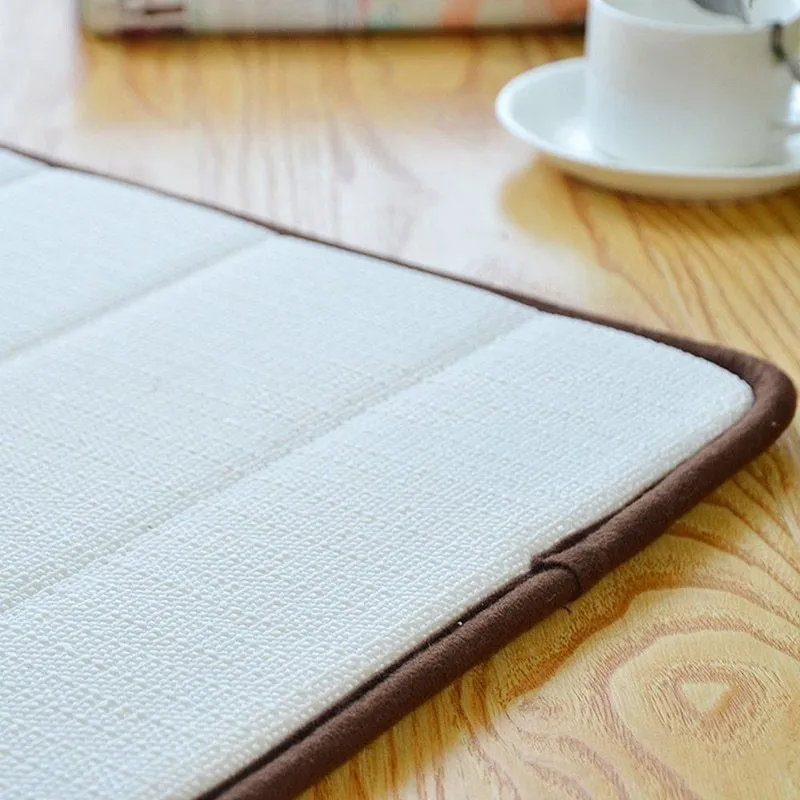 Coral fleece non-slip bath mat in 40x60cm size, placed on bathroom floor with water absorbent surface