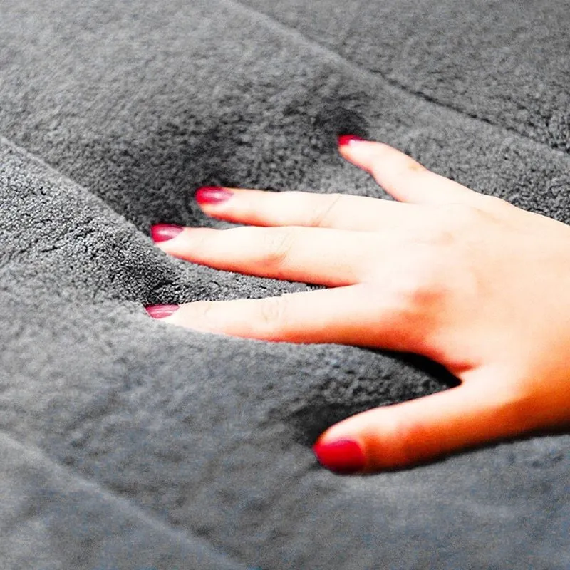 Coral fleece non-slip bath mat in 40x60cm size, placed on bathroom floor with water absorbent surface