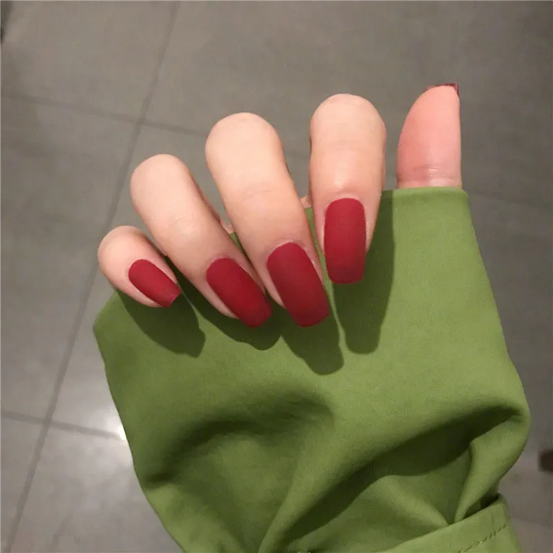 24 false nails in matte red medium length with glue adhesive in packaging