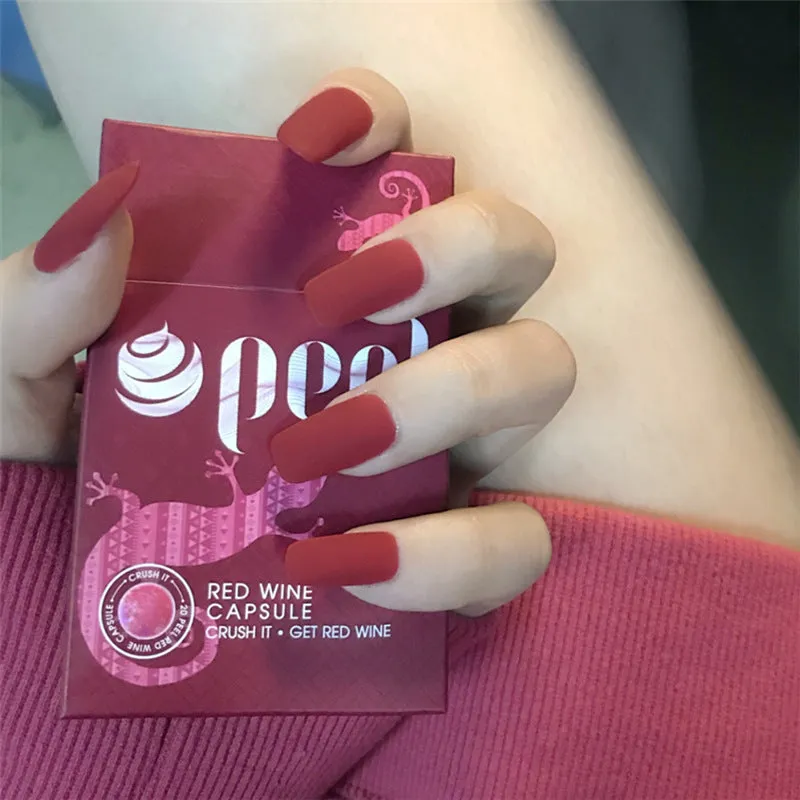 24 false nails in matte red medium length with glue adhesive in packaging
