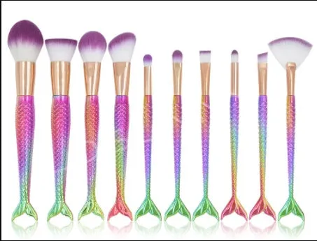 10 mermaid makeup brushes with multicolour nylon bristles and plastic handles laid flat