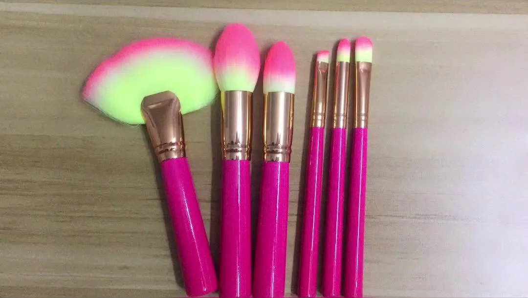 Pink wooden handle synthetic bristle makeup brush set in a compact case