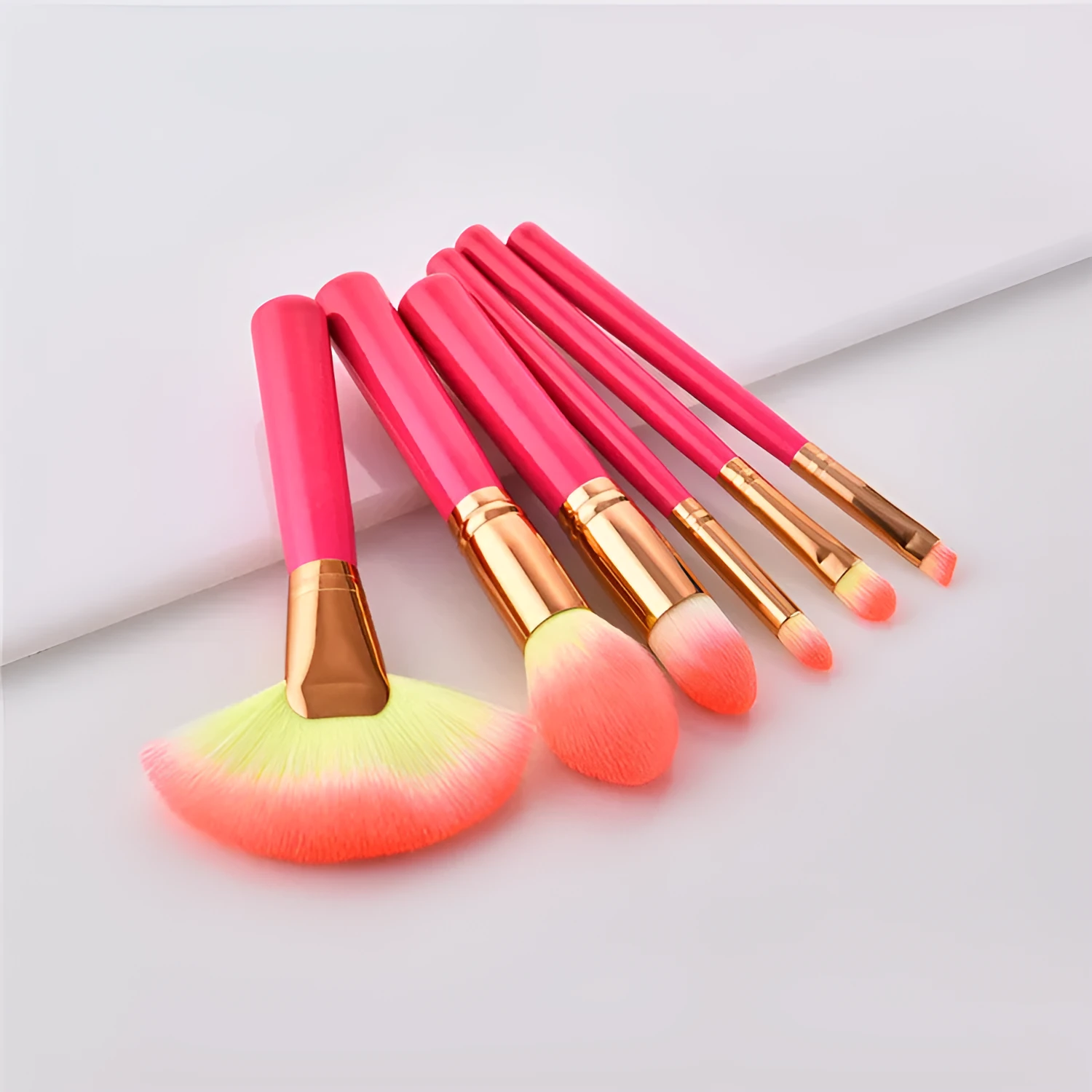 Pink wooden handle synthetic bristle makeup brush set in a compact case