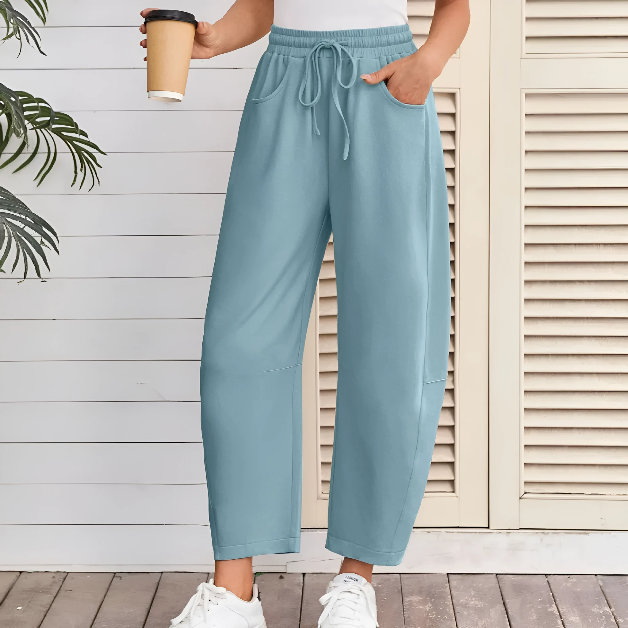 Women's loose cropped sweatpants in cotton fabric with elastic drawstring waistband in street fashion styling