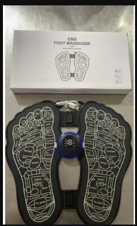 Black rechargeable foldable EMS foot massager pad with control host on floor