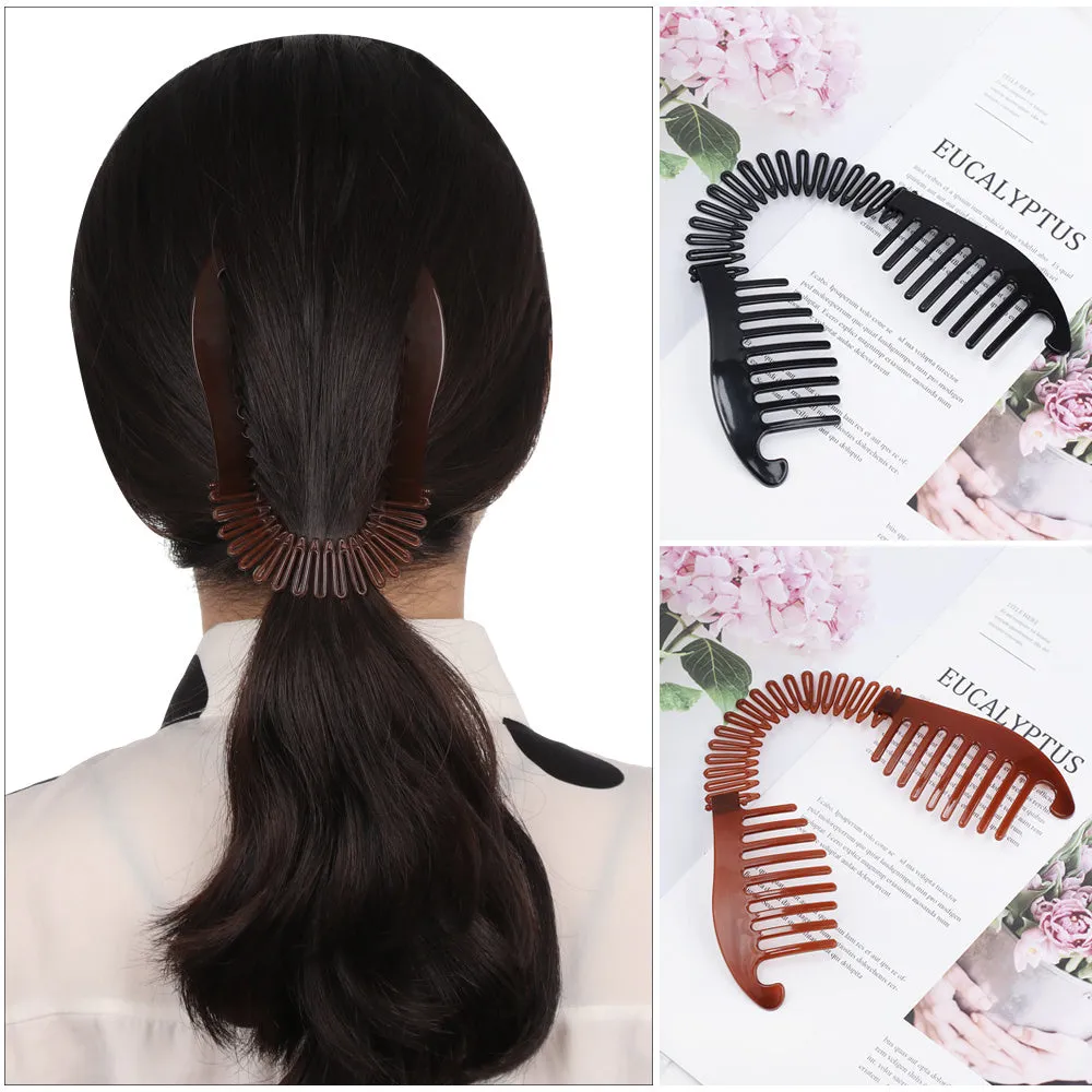 Retro fish-shaped hair claw clip in black with metal accents and adjustable hairband on a flat surface