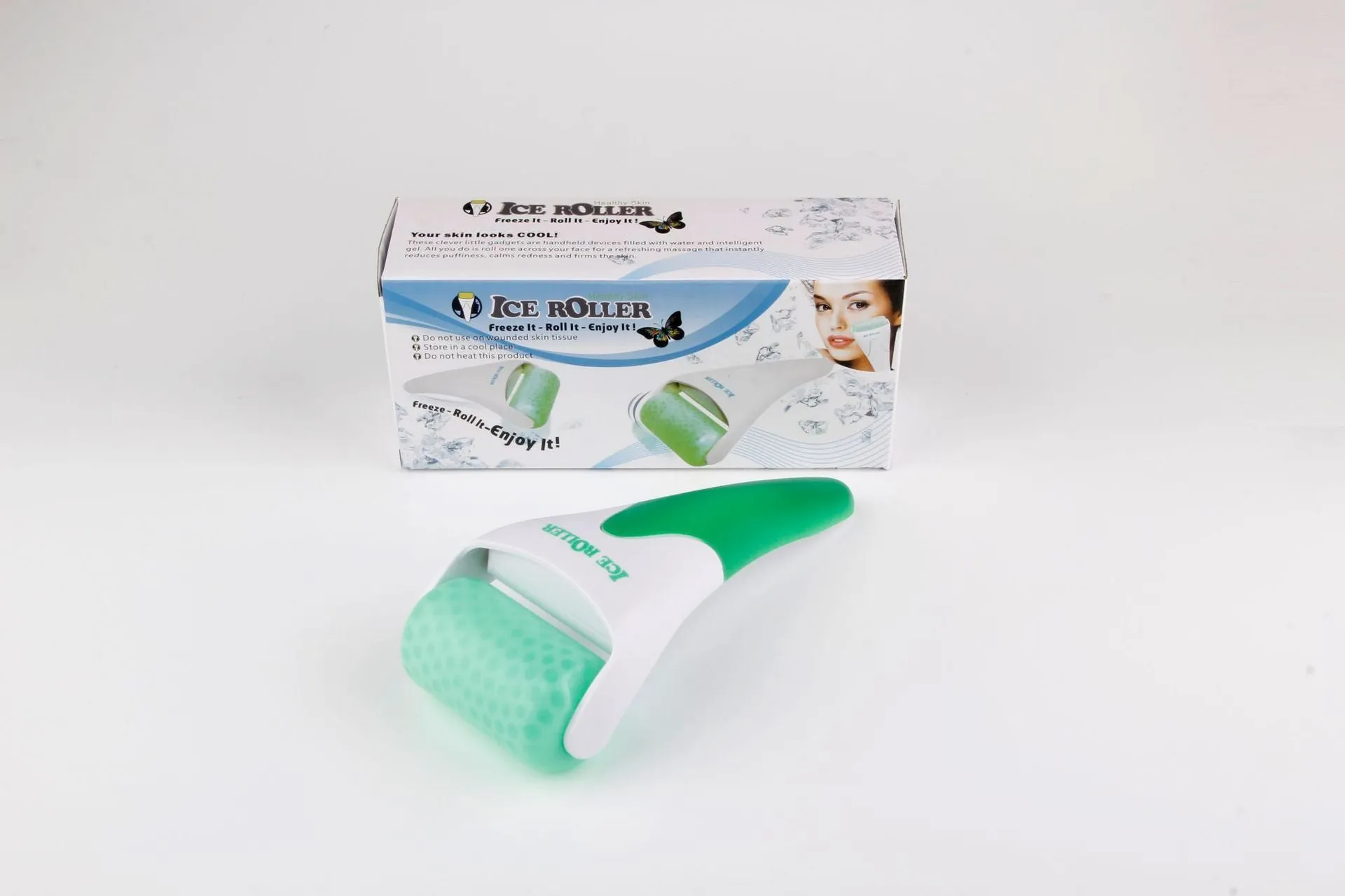 Plastic ice roller face roller in blue with removable head on white background
