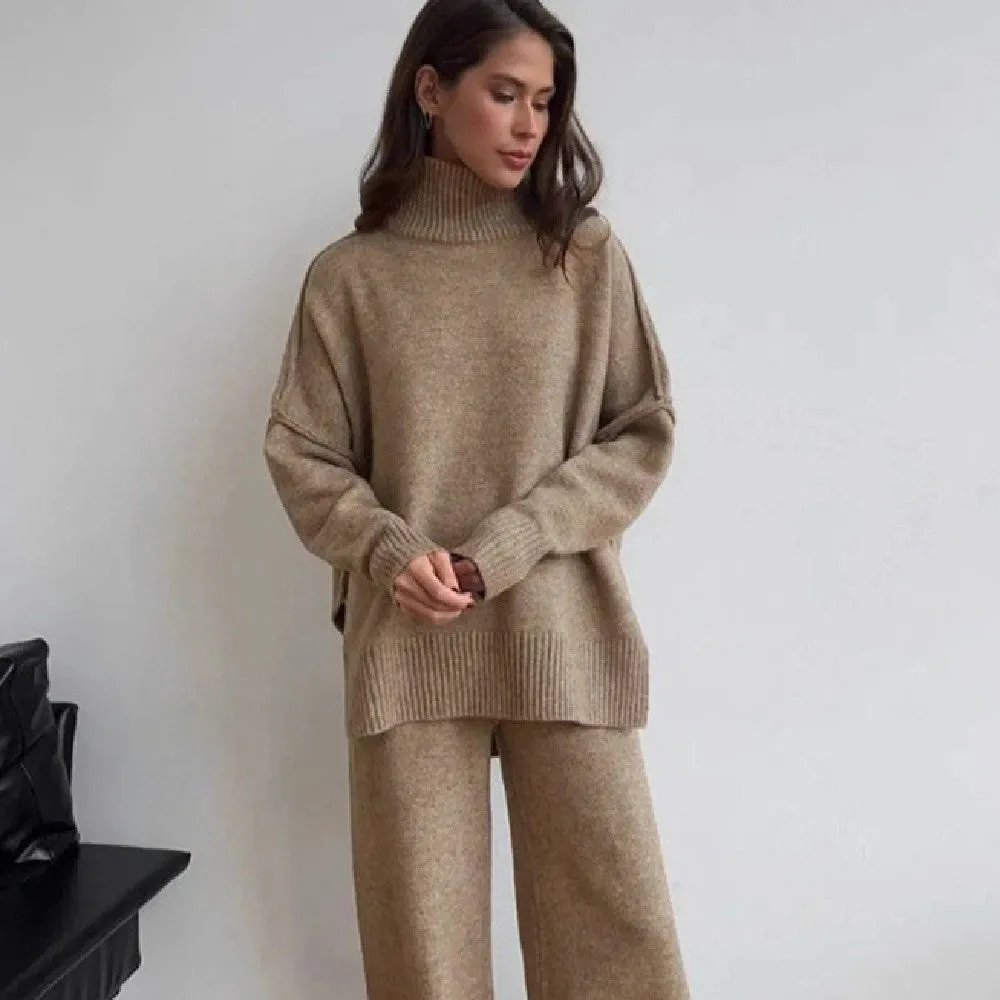 Dark grey women's knitted side-slit top and matching trousers set on a hanger
