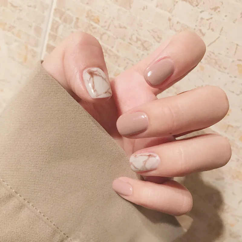 24 light khaki smudge false nails with glue in almond shape on white background