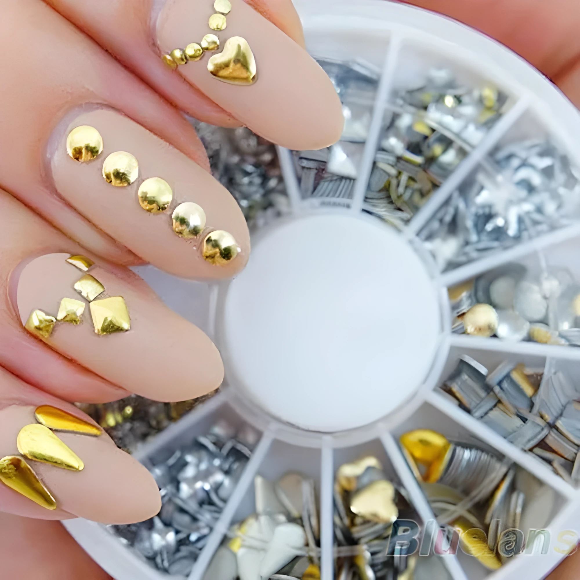Gold and silver acrylic nail art stickers on a white backing sheet, ready for DIY nail decoration