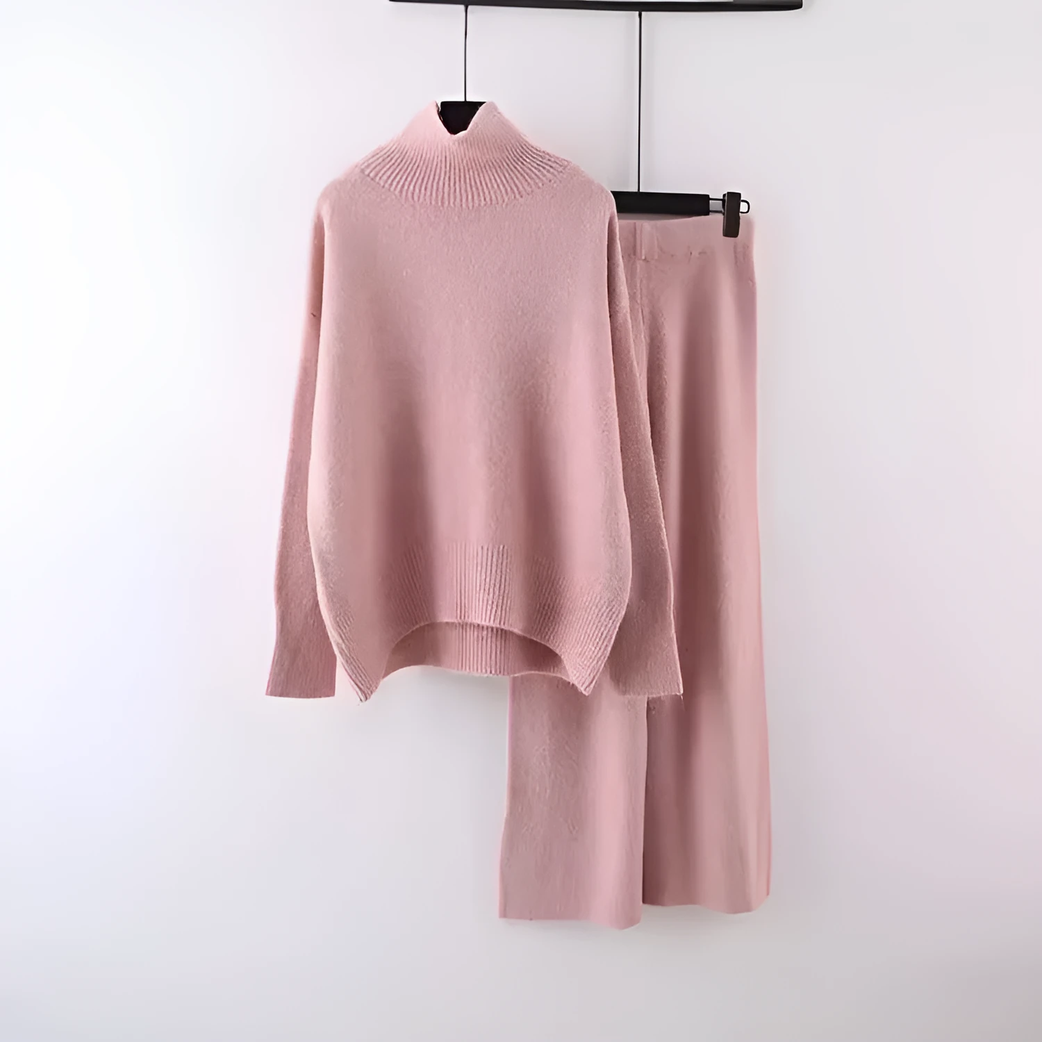 Women's milky white acrylic two-piece set with long sleeve top and wide-leg trousers on a hanger.