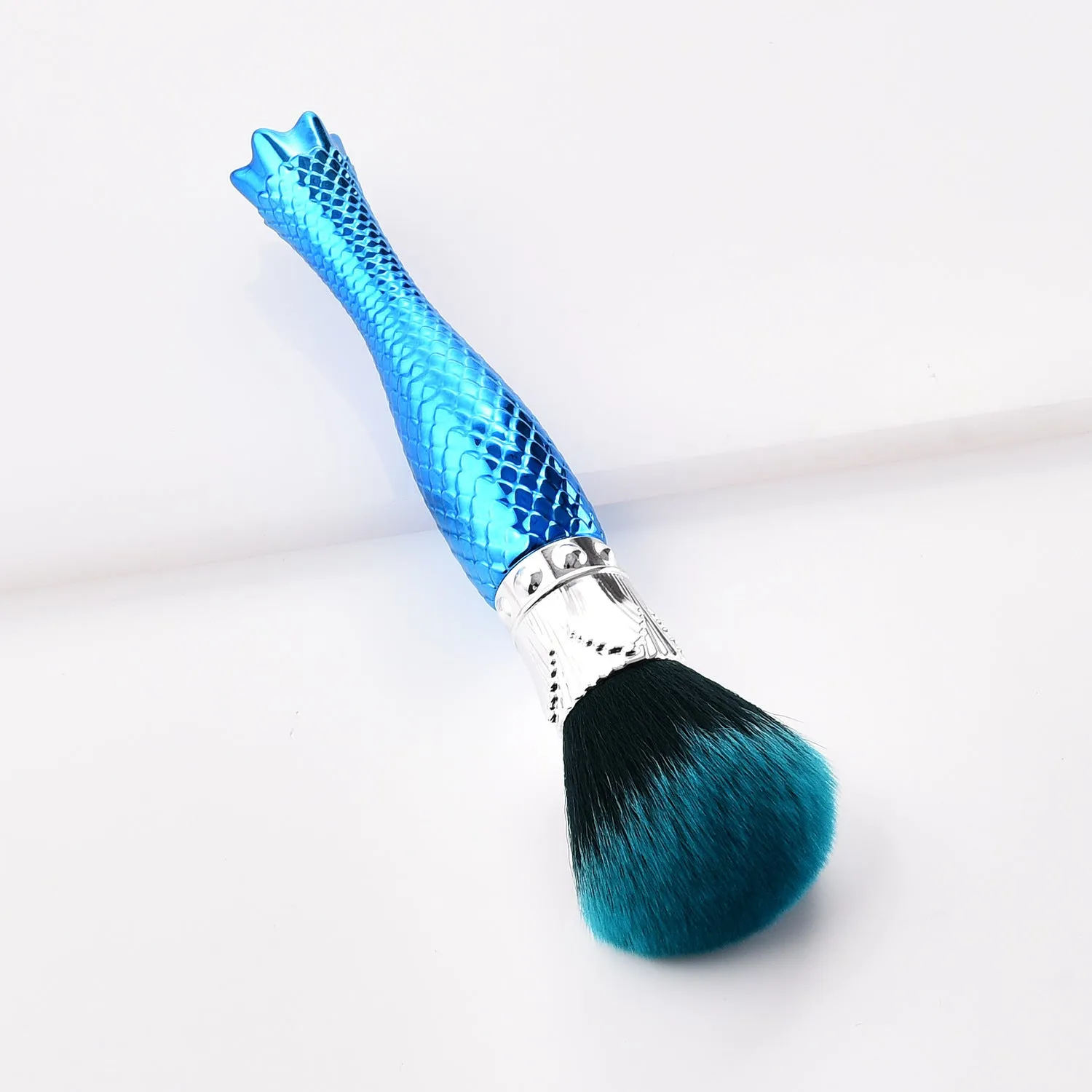 Demon blue single makeup brush with nylon bristles and plastic handle on white background