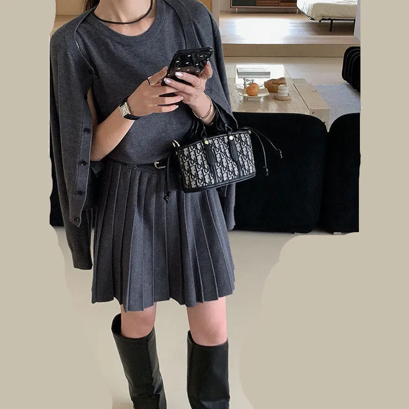 Grey Art Retro style women's knitted vest skirt and long-sleeved cardigan two-piece set with a 3D pattern.