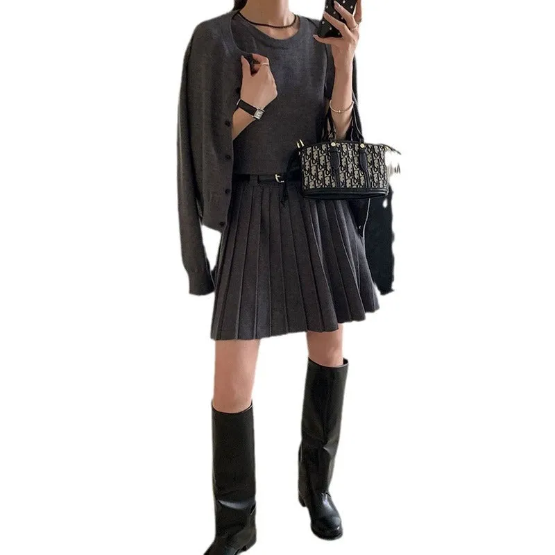 Grey Art Retro style women's knitted vest skirt and long-sleeved cardigan two-piece set with a 3D pattern.