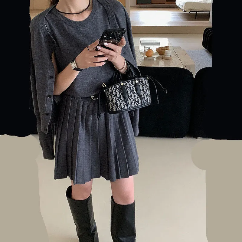 Grey Art Retro style women's knitted vest skirt and long-sleeved cardigan two-piece set with a 3D pattern.