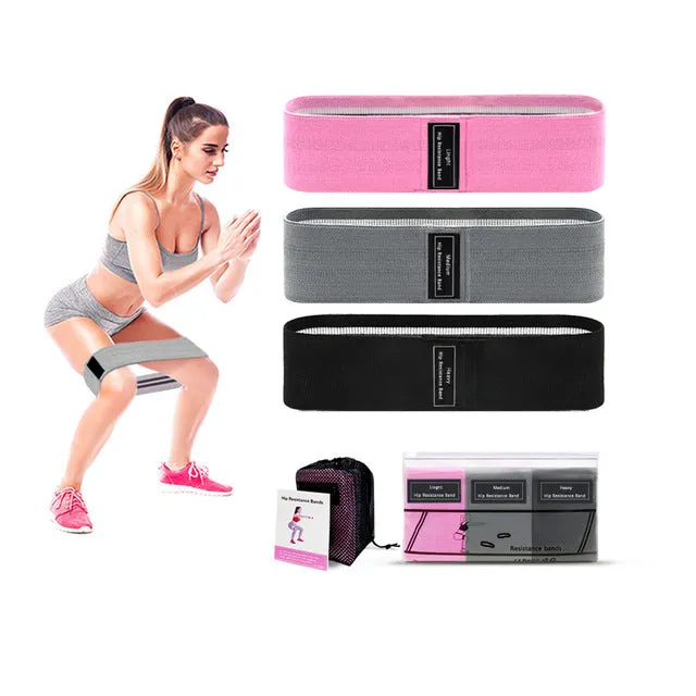 Fabric resistance bands set in lake blue, pink, and purple on a neutral background with net bag