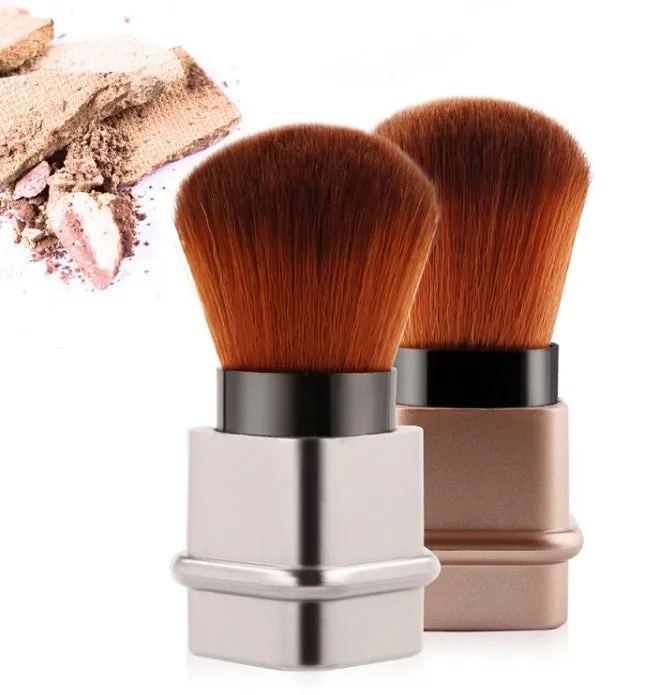 Portable single makeup brush with man-made fibre bristles and square gold plastic handle on white background