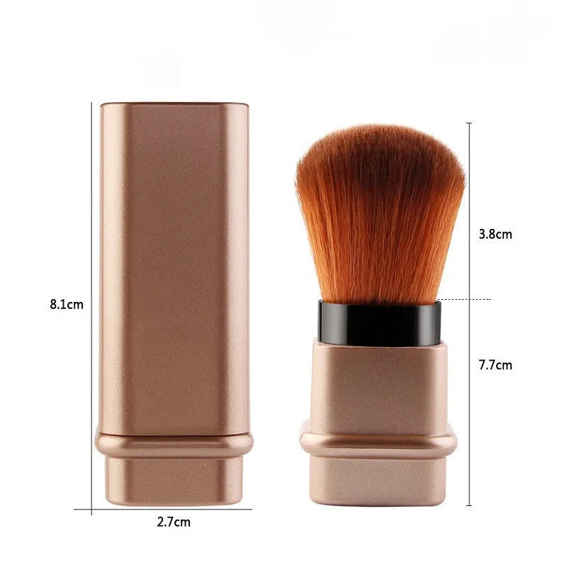 Portable single makeup brush with man-made fibre bristles and square gold plastic handle on white background