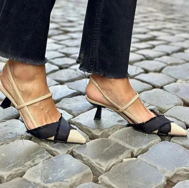 Women's apricot and black colour-block stiletto heel sandals with pointed toe and buckle fastening.