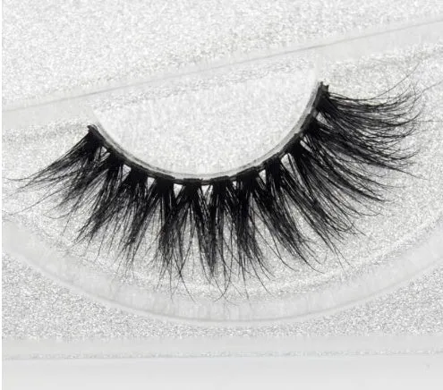 Pair of faux mink eyelashes with long tail and cotton stem against white background