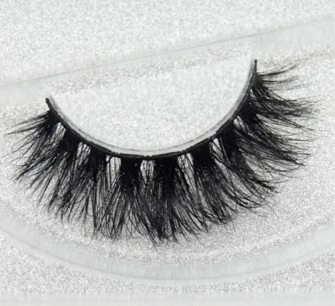 Pair of faux mink eyelashes with long tail and cotton stem against white background