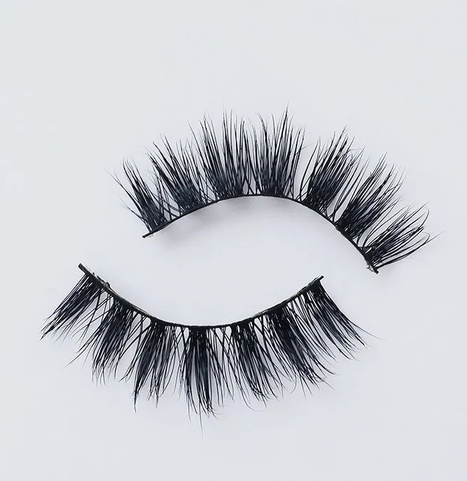 Pair of faux mink eyelashes with long tail and cotton stem against white background