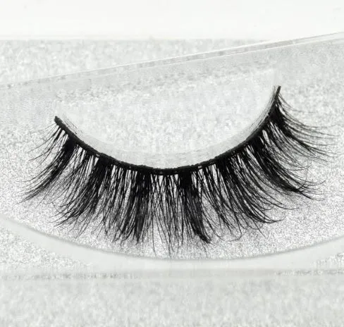 Pair of faux mink eyelashes with long tail and cotton stem against white background