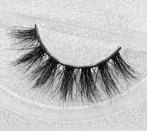 Pair of faux mink eyelashes with long tail and cotton stem against white background