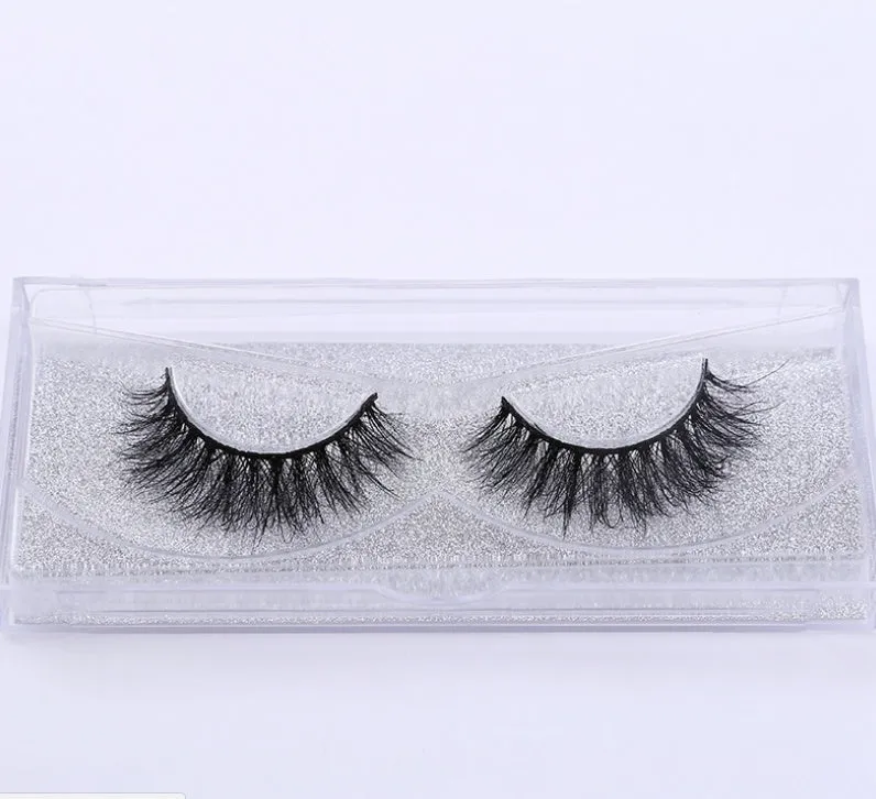 Pair of faux mink eyelashes with long tail and cotton stem against white background