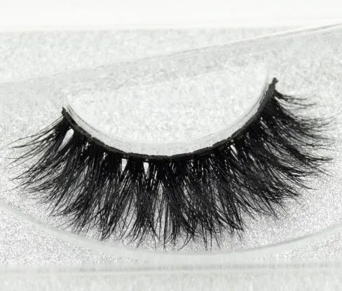 Pair of faux mink eyelashes with long tail and cotton stem against white background