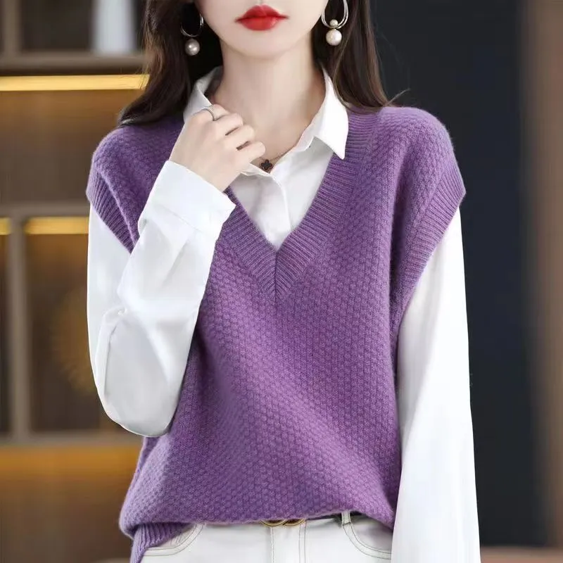 Women's creamy-white V-neck sleeveless knitted vest with a 3D pattern, laid flat.