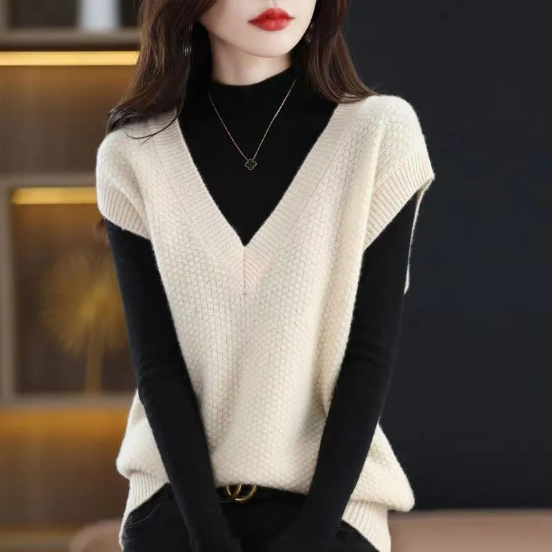 Women's creamy-white V-neck sleeveless knitted vest with a 3D pattern, laid flat.