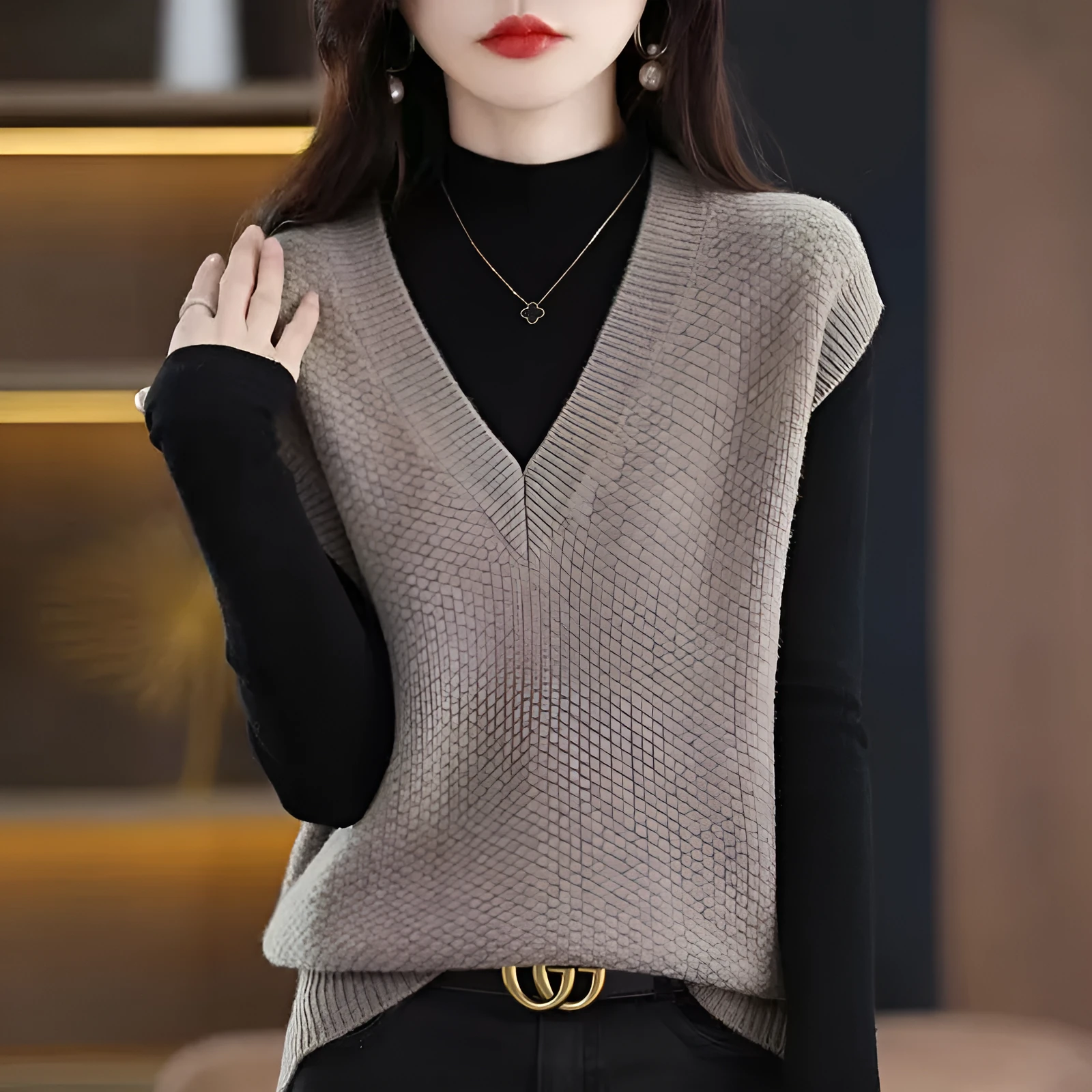 Women's creamy-white V-neck sleeveless knitted vest with a 3D pattern, laid flat.