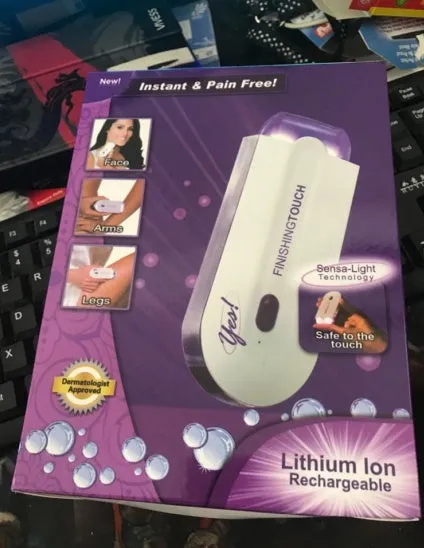 White cordless laser hair removal machine with purple sensa-light technology, trimmer and microfoil heads, 12cm length