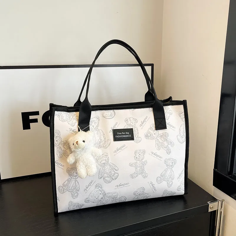 Women's black canvas tote bag with rhombus pattern and sandwich pocket compartments