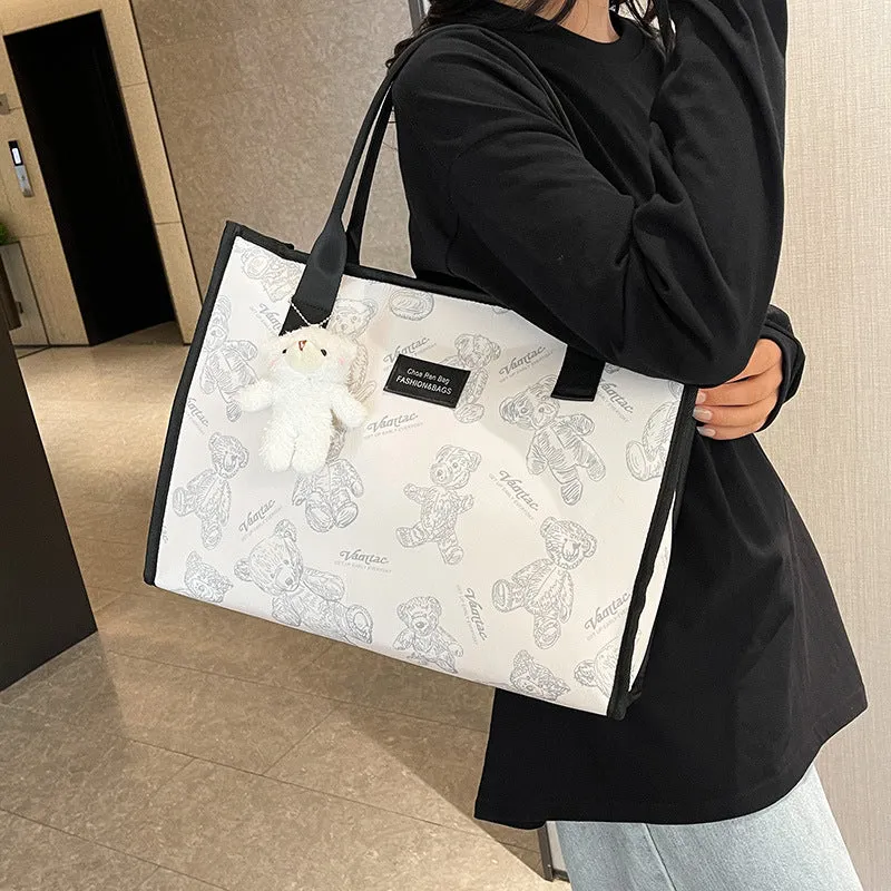 Women's black canvas tote bag with rhombus pattern and sandwich pocket compartments