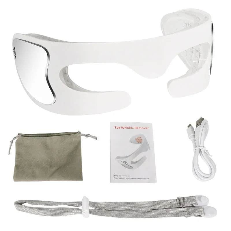 White portable rechargeable red light eye massager on a table