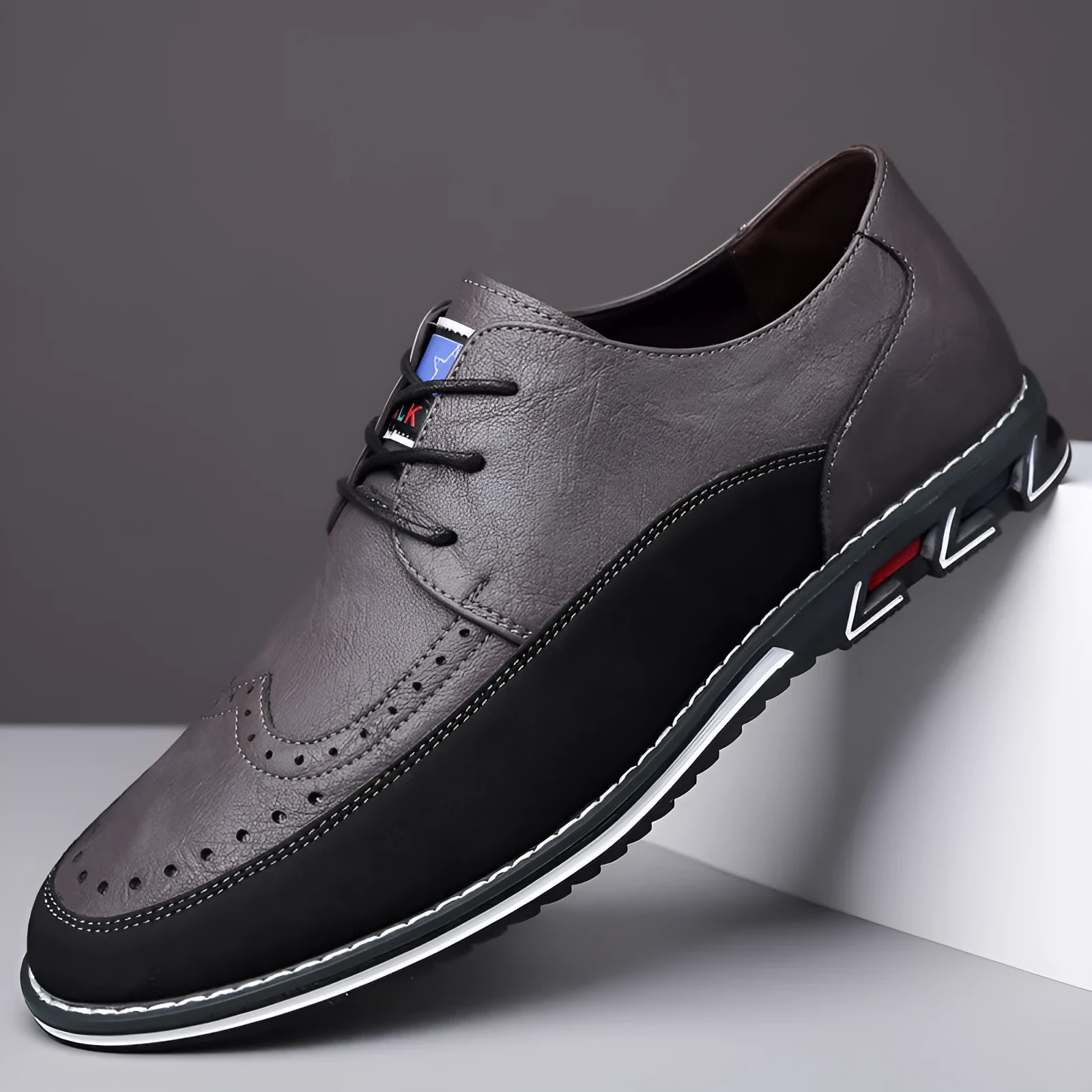 Men's low-top casual leather shoes with a leather toe cap and sewing line detail on fabric upper.