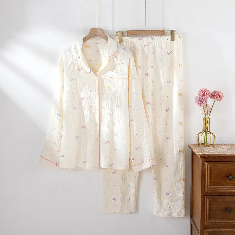 Women's beige long-sleeved cotton pajama top and trouser set laid flat.