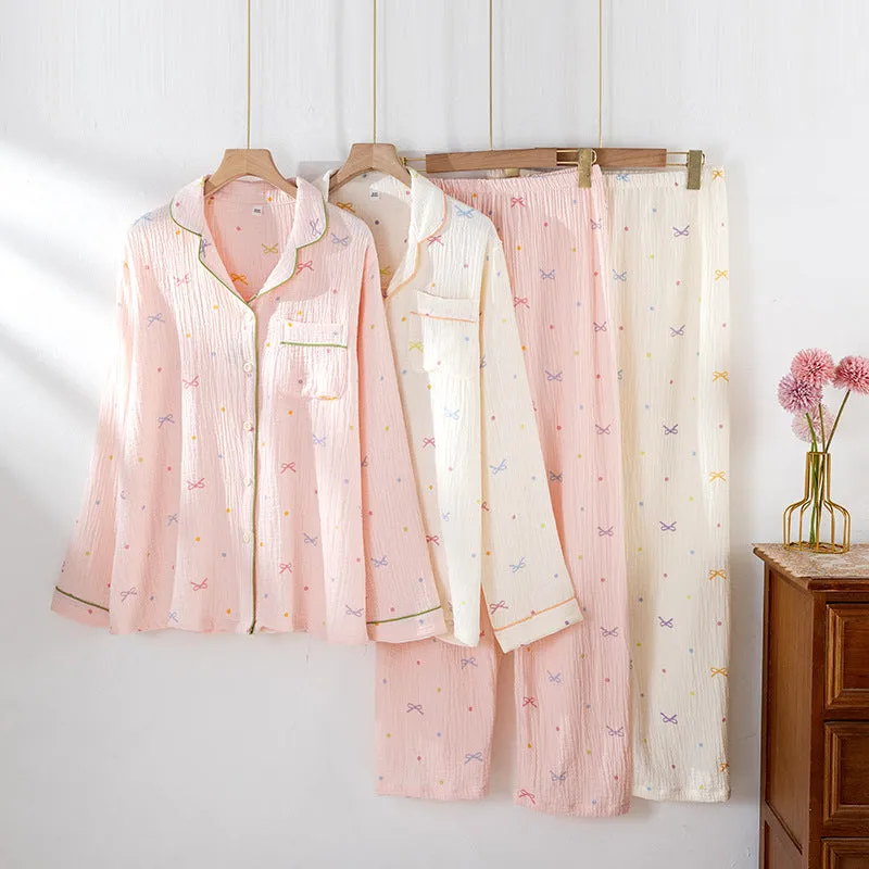 Women's beige long-sleeved cotton pajama top and trouser set laid flat.