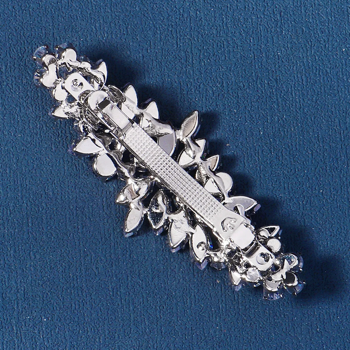 Women's inlaid zircon spring clip barrette with leaf pattern, electroplated finish, side view
