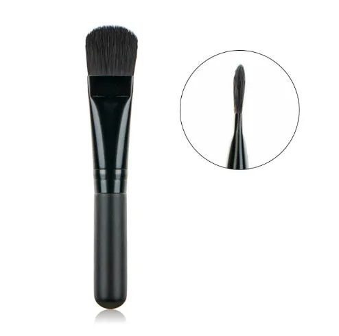 Wooden handle portable facial treatment brush with artificial fibre bristles on white background