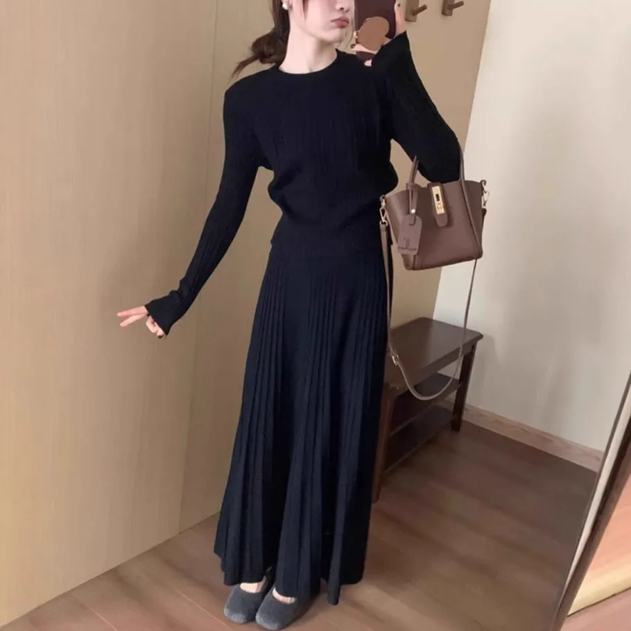 Dark grey knitted two-piece dress suit with 3D pattern, showing sweater and skirt.