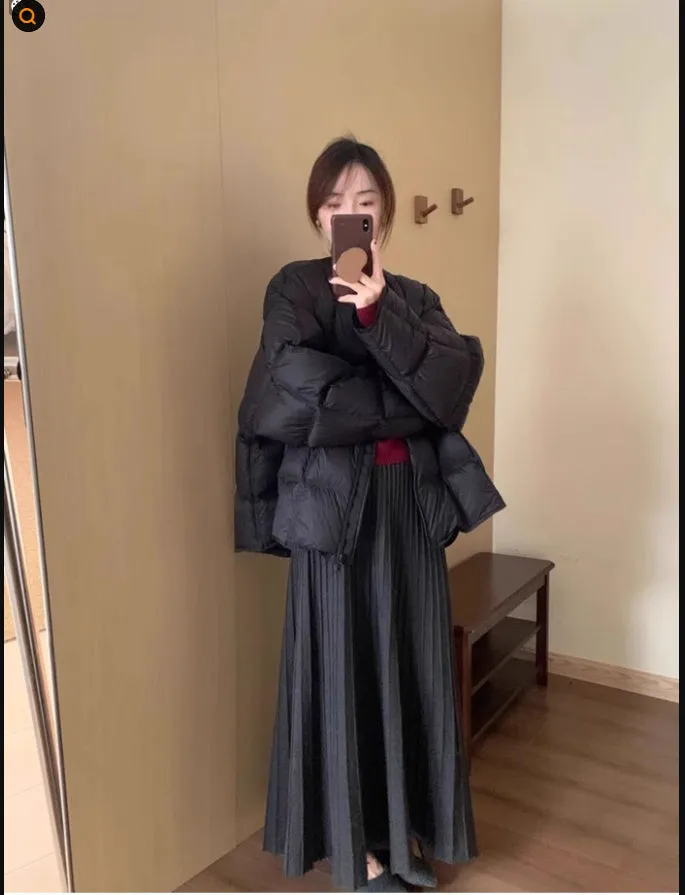 Dark grey knitted two-piece dress suit with 3D pattern, showing sweater and skirt.